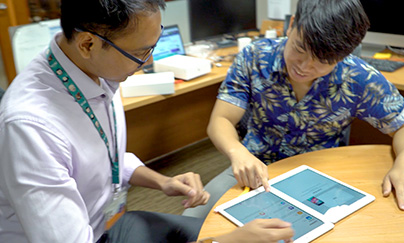 Staff and student looking at tablets