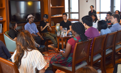 Four people sitting in the front chair, facing the audience for an intergroup dialogue at the Saga College Rector’s Commons.