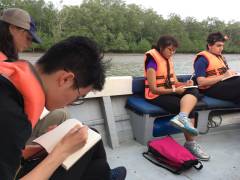 Students at a field trip jotting notes