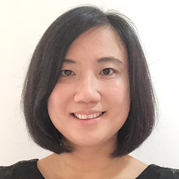 A headshot of smiling Ng Hui Khoon who has short black hair in a bob cut. She is wearing a black blouse.