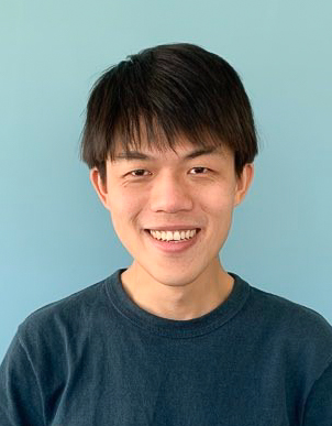 A headshot of smiling Lee Yi-Chieh who has short black hair and a fringe. He is wearing a dark blue t-shirt.
