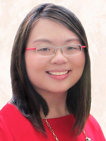 A headshot of smiling Sarah Shi Hui Wong who has short black-brown hair of shoulder length. She is wearing glasses with a grey and red frame and a red blouse and a gold necklace.